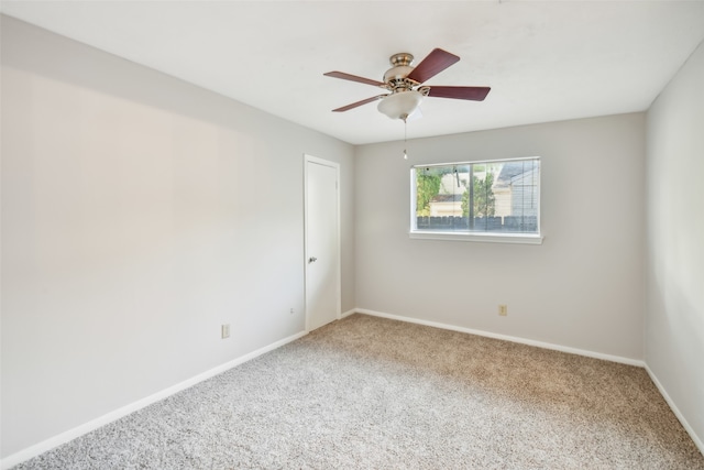 carpeted spare room with ceiling fan