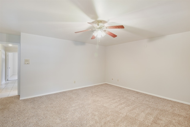 empty room with light colored carpet and ceiling fan