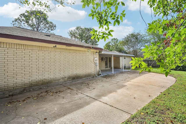 view of side of property with a patio area