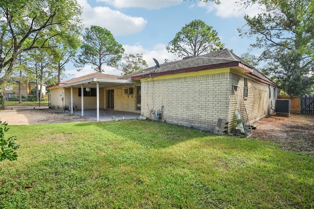 rear view of property featuring a yard and a patio area