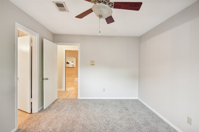 carpeted spare room with ceiling fan