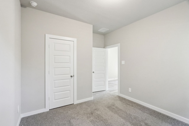 unfurnished bedroom with light carpet