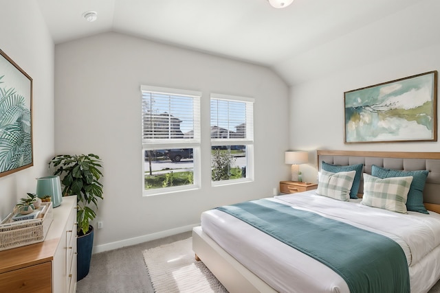 carpeted bedroom featuring vaulted ceiling