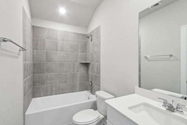 full bathroom with vanity, tiled shower / bath combo, and toilet