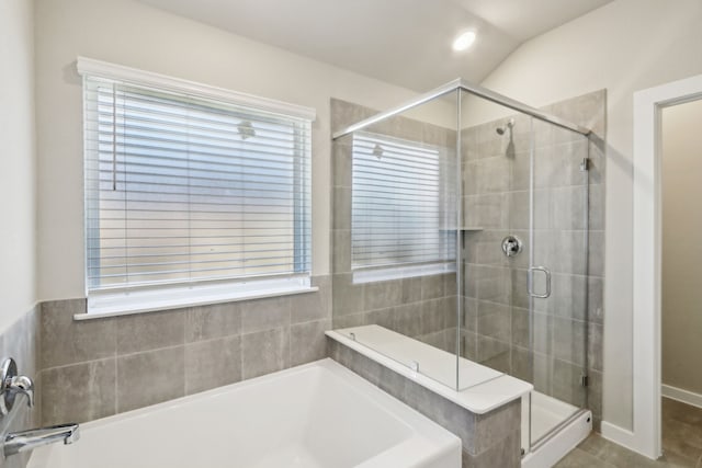 bathroom featuring a healthy amount of sunlight, tile patterned flooring, and separate shower and tub