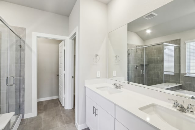 bathroom with tile patterned floors, vanity, and a shower with shower door