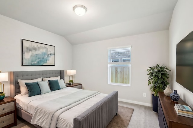 carpeted bedroom with vaulted ceiling