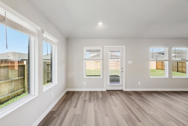 unfurnished room featuring plenty of natural light and light hardwood / wood-style flooring