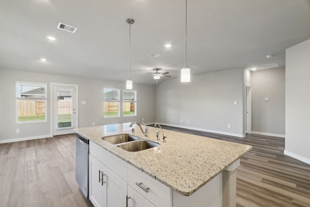 kitchen with pendant lighting, sink, an island with sink, white cabinets, and stainless steel dishwasher