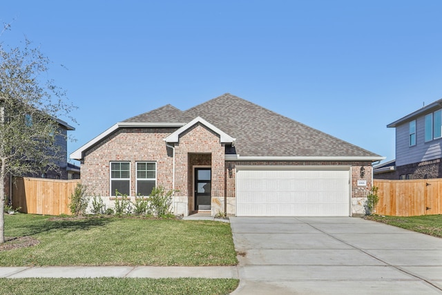 view of front of home with a garage and a front yard