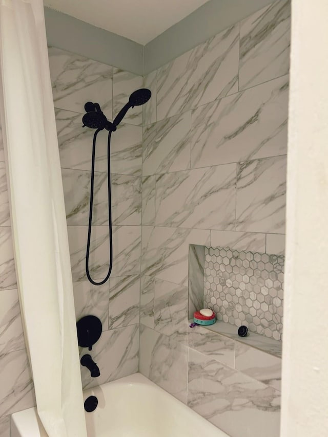 bathroom with shower / bath combination with curtain