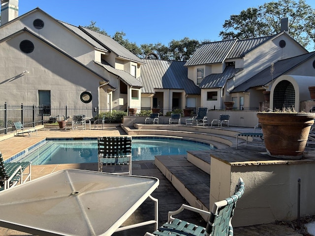 view of swimming pool featuring a patio area