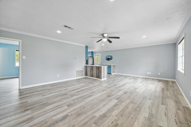 unfurnished living room featuring crown molding, ceiling fan, light hardwood / wood-style floors, and a textured ceiling