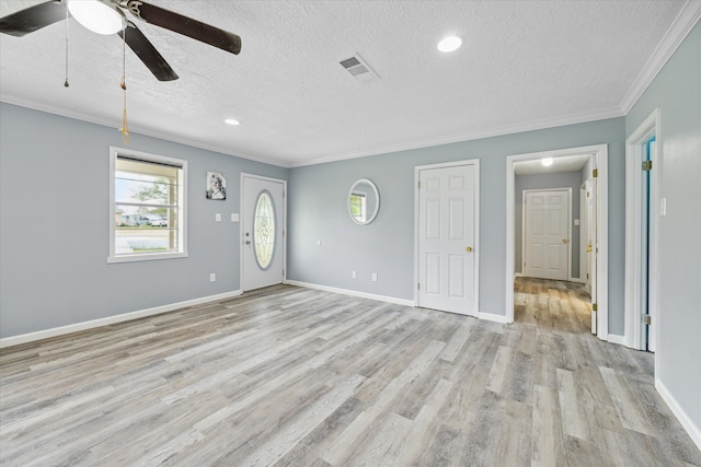 unfurnished living room with ceiling fan, light hardwood / wood-style floors, a textured ceiling, and ornamental molding