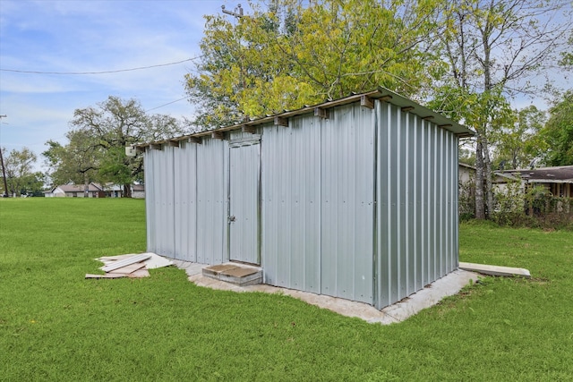 view of outbuilding with a lawn