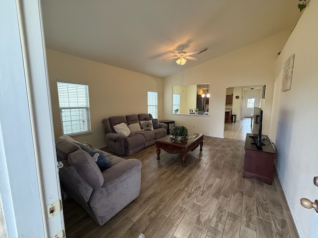 living room with lofted ceiling, hardwood / wood-style floors, and ceiling fan