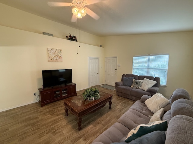 living room with lofted ceiling, hardwood / wood-style flooring, and ceiling fan