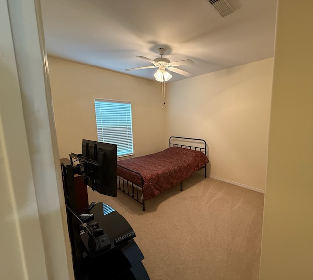 bedroom with ceiling fan and carpet floors