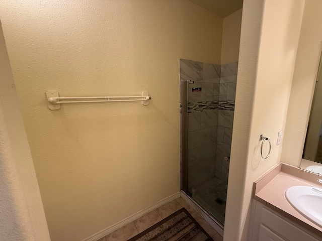 bathroom featuring vanity and a shower with door