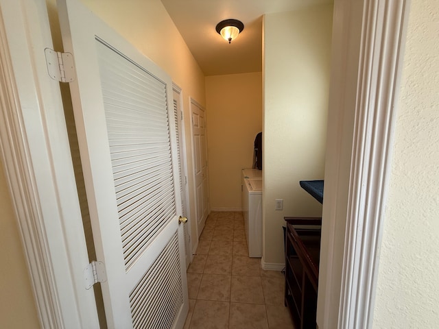 laundry area featuring light tile patterned flooring and washer and clothes dryer