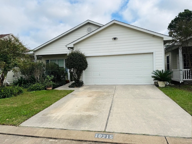 ranch-style home with a garage and a front lawn