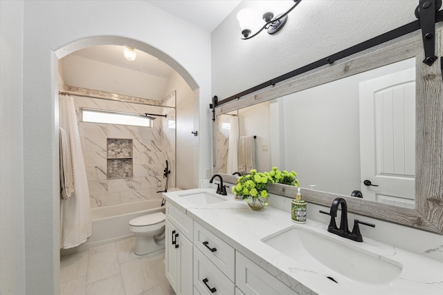 full bathroom with vanity, shower / tub combo, and toilet