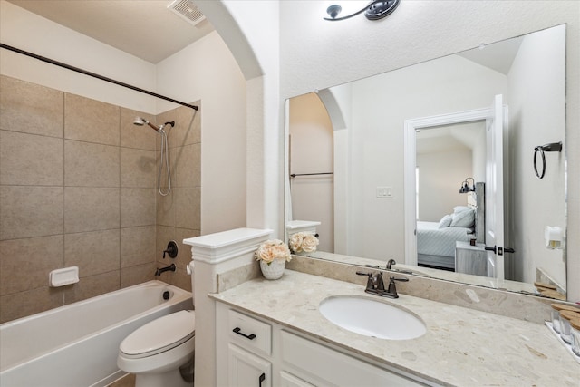 full bathroom featuring vanity, toilet, and tiled shower / bath