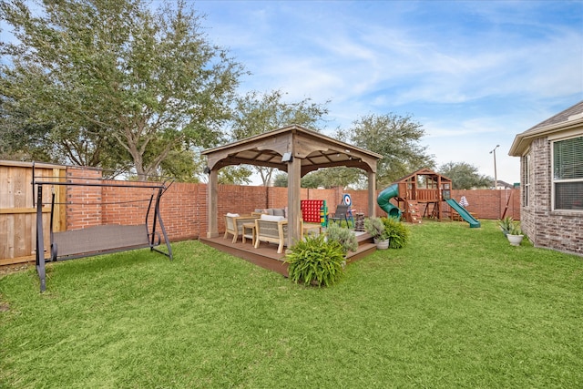 view of yard with outdoor lounge area, a gazebo, a playground, and a deck