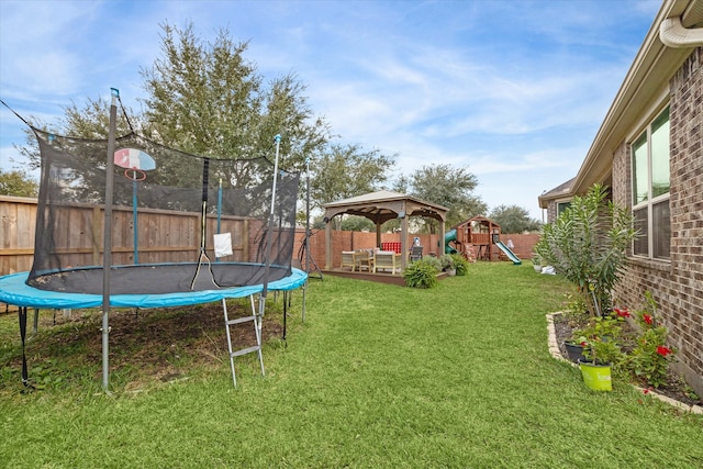 view of yard with a playground, a gazebo, and a trampoline