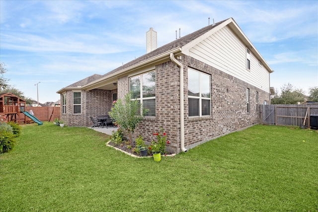 view of home's exterior with a playground, a yard, and a patio