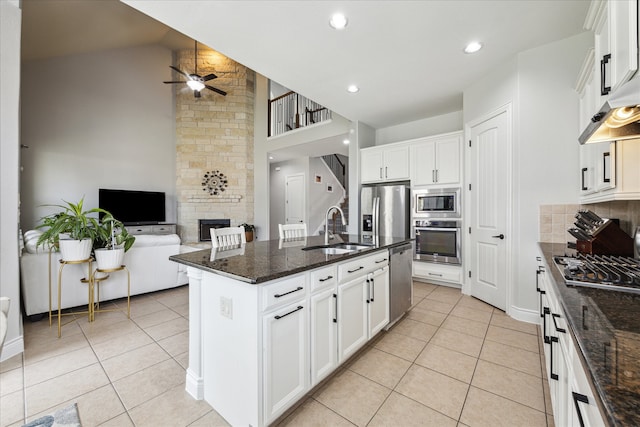 kitchen featuring white cabinets, sink, a kitchen island with sink, and stainless steel appliances