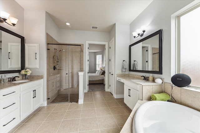 bathroom featuring tile patterned floors, vanity, and plus walk in shower