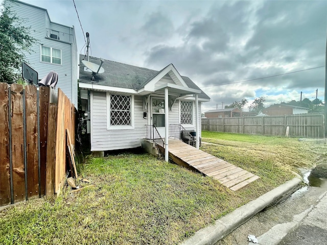 bungalow-style home with a front lawn