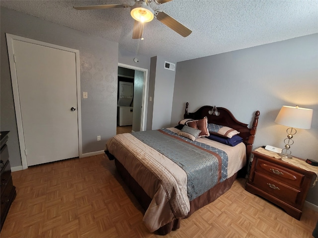 bedroom with ceiling fan, a textured ceiling, and parquet floors