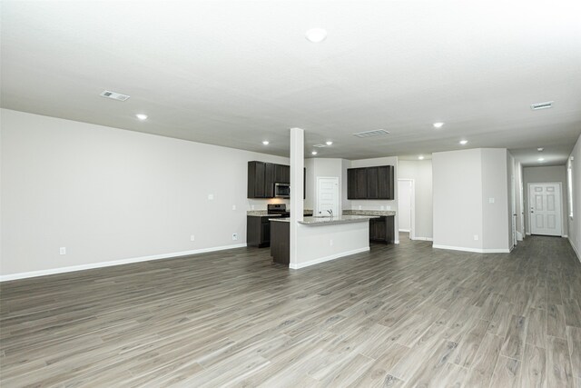 unfurnished living room with dark hardwood / wood-style flooring