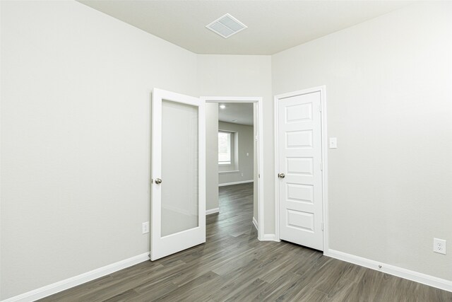 empty room with dark wood-type flooring