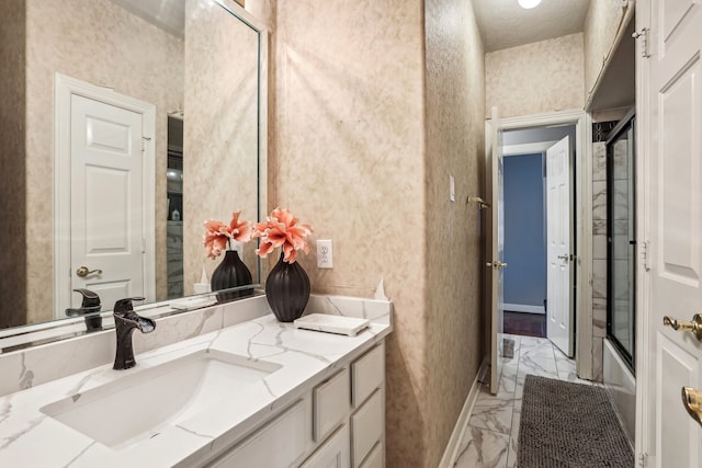 bathroom with vanity and bath / shower combo with glass door