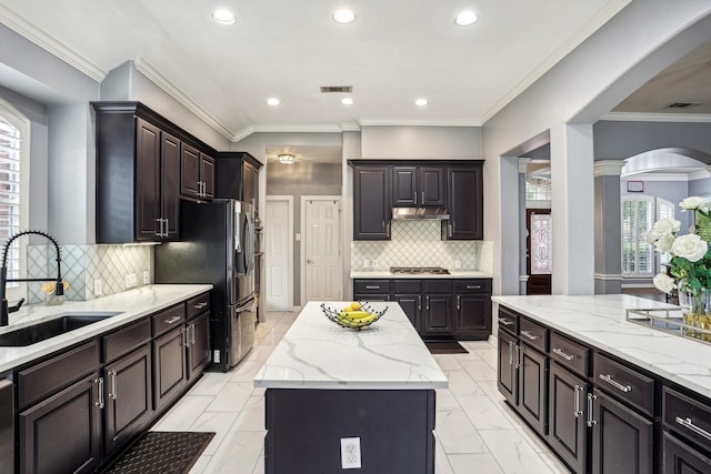 kitchen featuring sink, a kitchen island, a healthy amount of sunlight, and appliances with stainless steel finishes