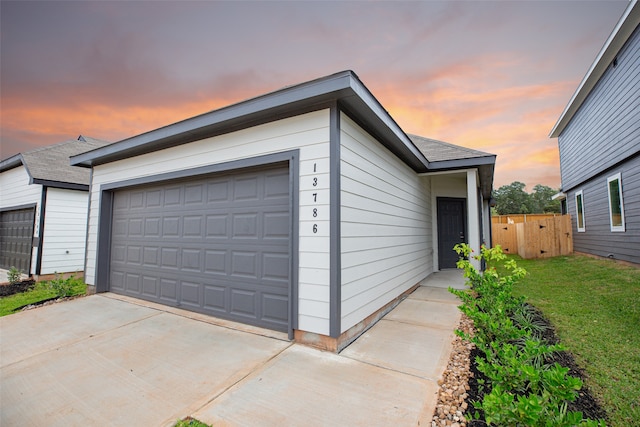 view of garage at dusk