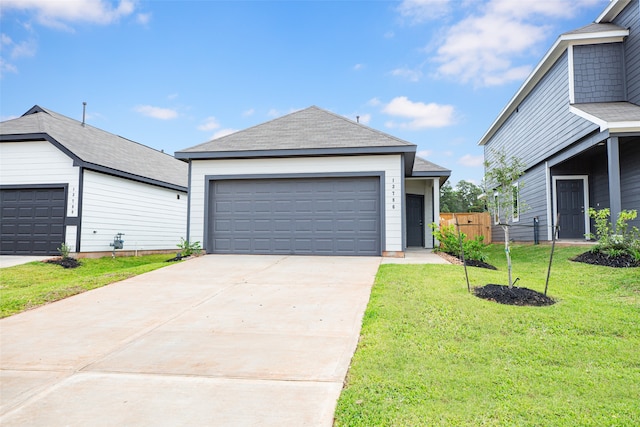 view of front of house featuring a garage and a front yard