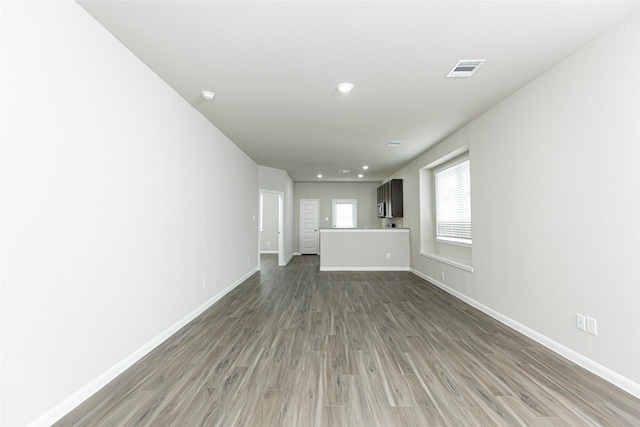 unfurnished living room with dark hardwood / wood-style flooring