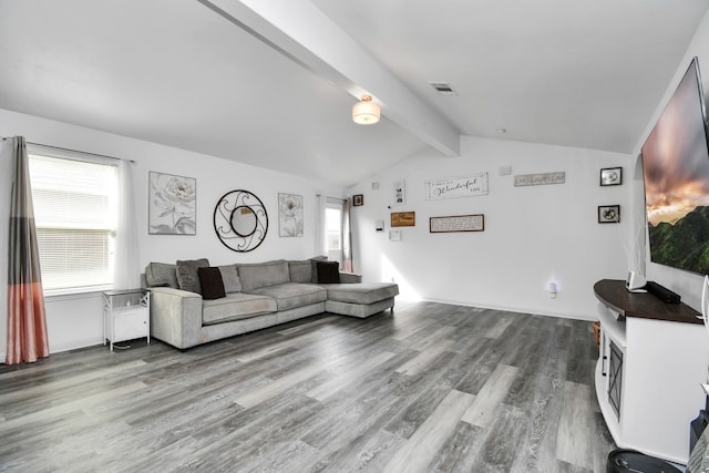 living room featuring hardwood / wood-style floors and vaulted ceiling with beams