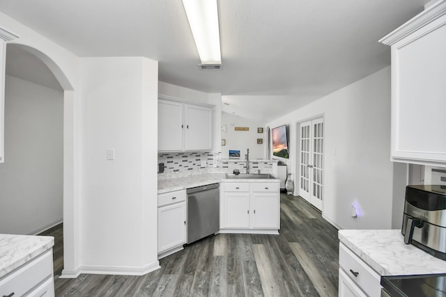 kitchen with white cabinetry, sink, backsplash, and dishwasher