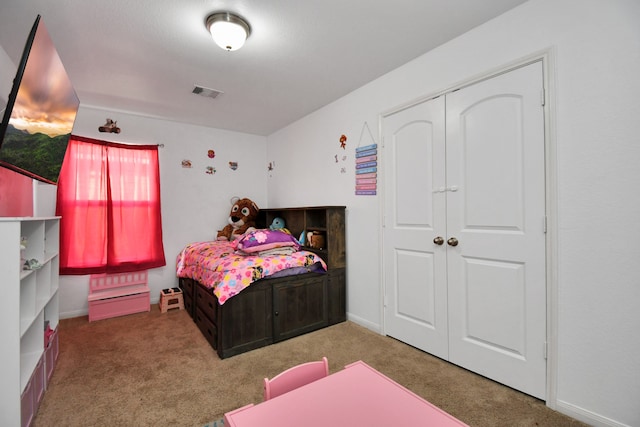 carpeted bedroom with a closet