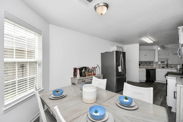 dining area featuring dark hardwood / wood-style floors