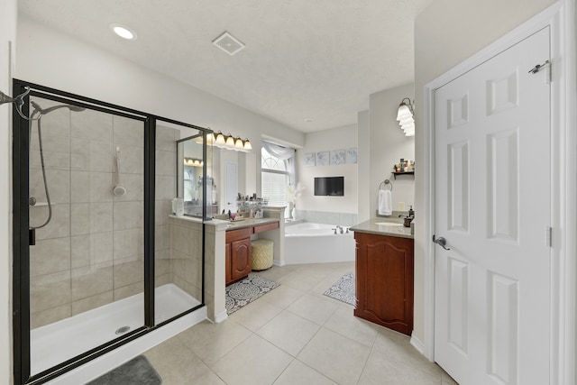 bathroom with separate shower and tub, tile patterned flooring, vanity, and a textured ceiling