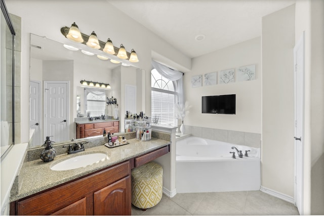 bathroom featuring tile patterned flooring, vanity, and a bathtub