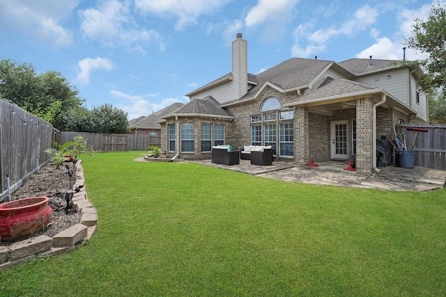 back of house with a patio area, an outdoor living space, a yard, and ceiling fan