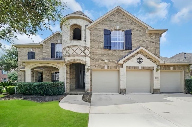 view of front of house with a front yard and a garage