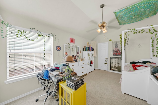 bedroom featuring ceiling fan, lofted ceiling, carpet floors, and multiple windows